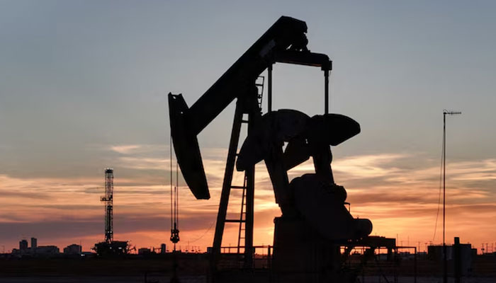 A drone view of a pump jack and drilling rig south of Midland, Texas, US June 11, 2025. — Reuters