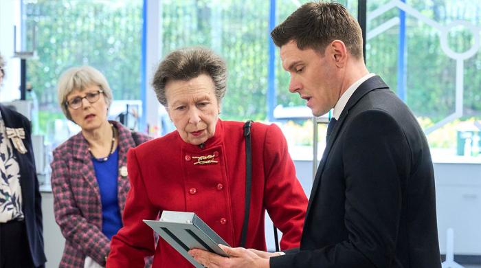 Princess Anne brings the heat while touring fire protection labs in bold red 