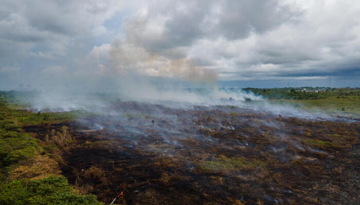 An aerial view of a landscape showing flames of a wildfire in Indonesia. — AFP