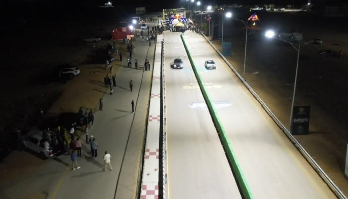 Cars race on a floodlit drag strip at a newly prepared motorsports facility in Karachi. — Reporter