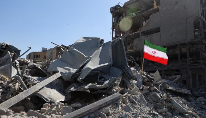 The national flag of Iran flies in the wind as debris lies scattered in the aftermath of an Israeli and US strike on a police station, amid the US-Israeli conflict with Iran, in Tehran, Iran. — Reuters