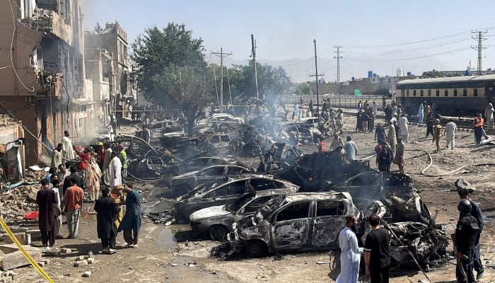 People and police officers gather after a blast near a railway track in Quetta, May 24, 2026. — Reuters