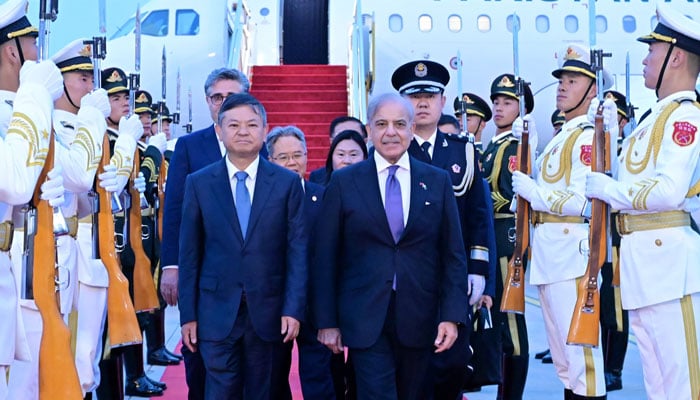 Chinese Minister for Environment and Ecology Huang Runqiu (left) receives PM Shehbaz Sharif upon arrival in Beijing on May 24, 2026. — X/@