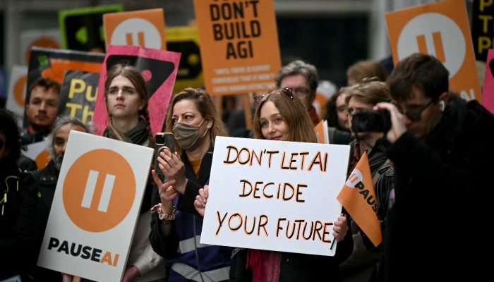 Protesters gather with banners and placards outside the offices of Google Deepmind at a protest organised by PauseAI UK and other groups concerned in controlling the development of advanced Artificial Intelligence systems, in London on February 28, 2026. — AFP