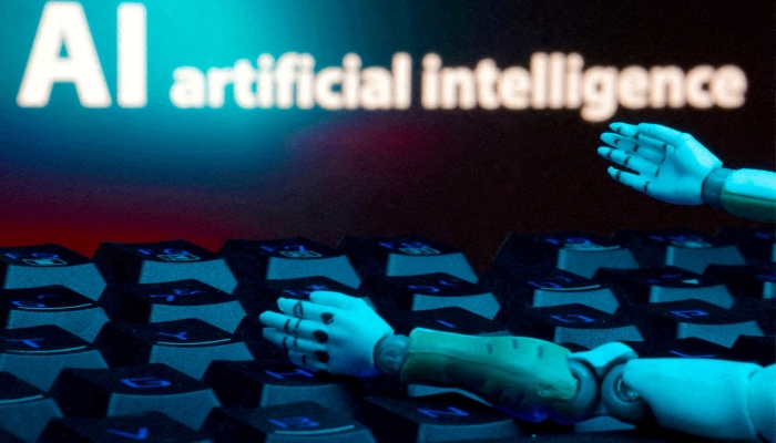 A message reading AI artificial intelligence, a keyboard and robot hands are seen in this illustration created on January 27, 2025. — Reuters