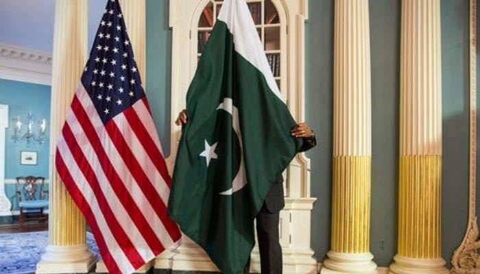 A State Department contractor adjusts a Pakistan national flag. — Reuters/File