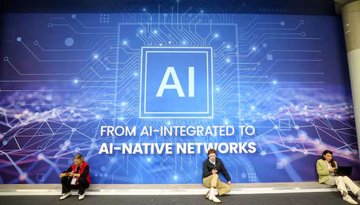 People rest sitting next to AI banner at the Mobile World Congress (MWC) at Fira de Barcelona, Spain, March 2, 2026. — Reuters
