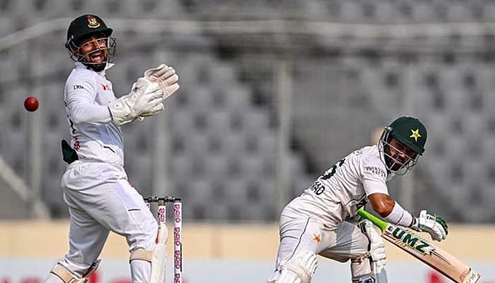 Pakistans Mohammad Rizwan (R) watches the ball after playing a shot as Bangladeshs wicketkeeper Litton Das reacts during the fifth day of the first Test cricket match between Bangladesh and Pakistan at the Sher-e-Bangla National Stadium in Mirpur on May 12, 2026. — AFP