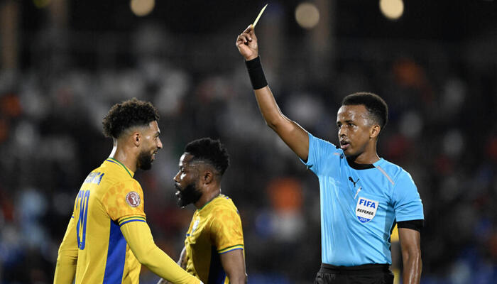 Somali referee Omar Abdulkadir Artan shows a card during a football game. – AFP
