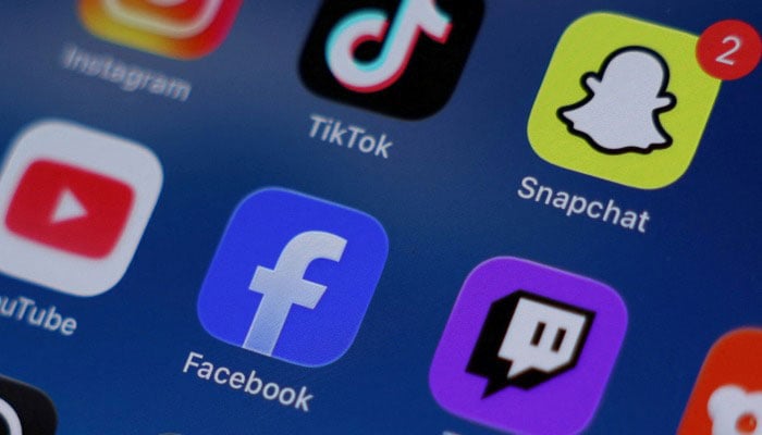 Instagram, TikTok, Snapchat, YouTube, Facebook, Twitch and Reddit applications are displayed on a mobile phone in this picture illustration taken on December 9, 2025. — Reuters