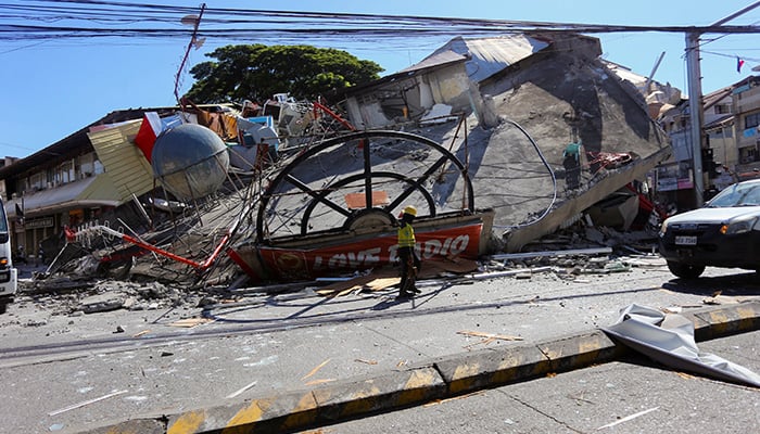 A worker walks near a collapsed building following the magnitude 7.8 quake in General Santos, southern Philippines, June 8, 2026. — Reuters