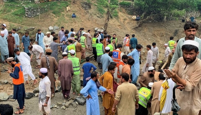 [2/3] Rescue workers and residents gather after cloudburst following the heavy rains and floodings, in Jibrari village in Salarzai Tehsil, Pakistan, August 15, 2025. — Reuters