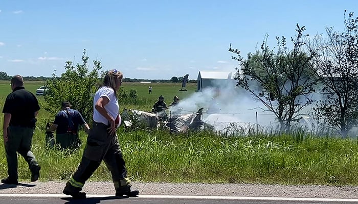 Firefighters work on the site of an aircraft crash in Butler, Missouri, US, June 14, 2026, in this still image taken from a video. — Reuters