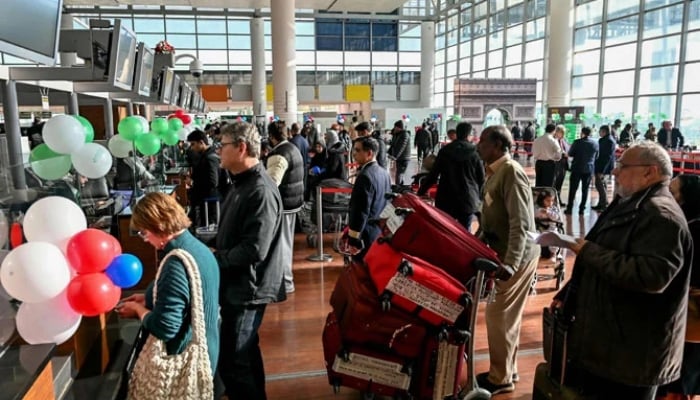 Passengers wait at the immigration counter before boarding at the Islamabad International Airport on January 10, 2025. — AFP