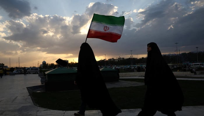 An Iranian woman holds Irans flag during a rally in Tehran, Iran, April 29, 2026. — Reuters