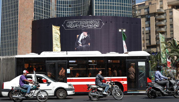 People drive past a billboard with a picture of the late Irans Supreme Leader Ayatollah Ali Khamenei, after US and Iranian officials said they had reached a deal to end their war and reopen the Strait of Hormuz, in Tehran, Iran, June 15, 2026.— Reuters