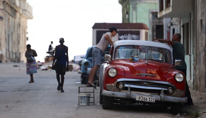 Men wash a vintage car on a street before the Cuban government presents far-reaching economic measures that could mark the most significant shift toward a market economy since the 1959 revolution, in Havana, Cuba, June 17, 2026. — Reuters