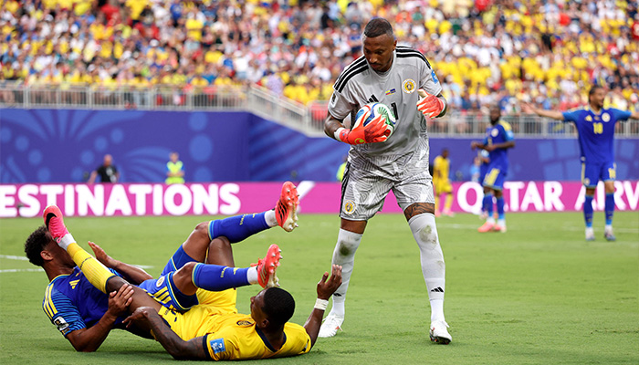 Eloy Room #1 of Curacao makes a save as teammate Jurien Gaari #3 collides with Pervis Estupinan #7 of Ecuador during the FIFA World Cup 2026 Group E match between Ecuador and Curacao at Kansas City Stadium on June 20, 2026 in Kansas City, Missouri. — AFP