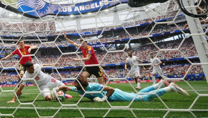 Irans Alireza Beiranvand makes a save during a clash against Belgium on June 21, 2026. — Retuers