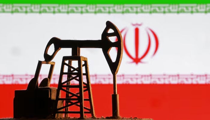 A model of an oil pump is seen in front of an Iranian flag in this illustration taken January 9, 2026