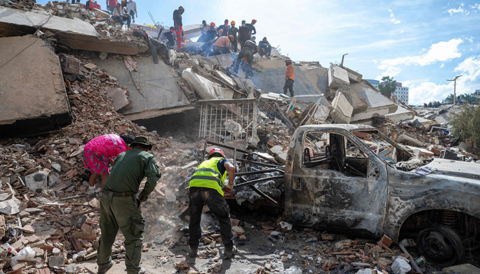 Rescuers and volunteers search for survivors on the rubble of a collapsed building in La Guaira state, Venezuela, on June 28, 2026, following earthquakes. — AFP