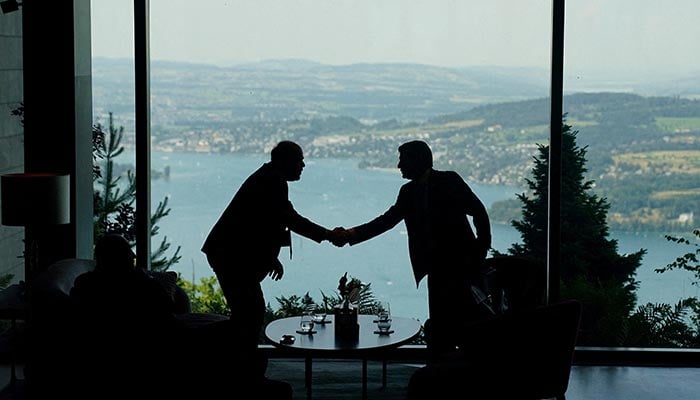 Delegation staff members meet in the lobby on the day of a quadrilateral meeting between the US, Iran, Pakistan, and Qatar at the Lake Lucerne Summit, Buergenstock Resort Lake Lucerne, near Stansstad, Switzerland, June 21, 2026. — Reuters