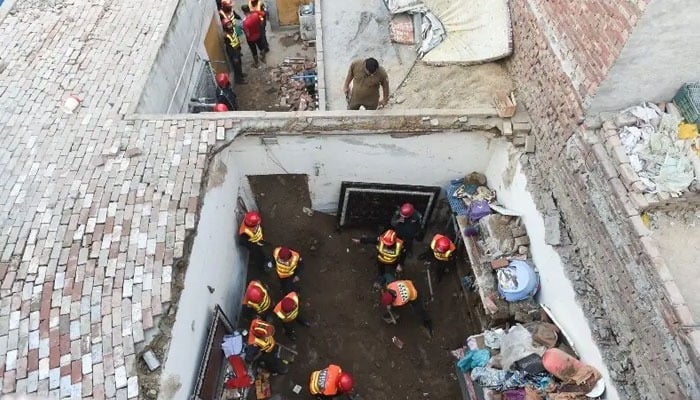 Rescue workers work at the site where children reportedly died after a tuition center roof collapsed, in Lahore on June 30, 2026. — Reuters