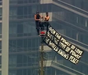 Russian daredevils unfurl banner atop New York's Empire State Building in proposal stunt