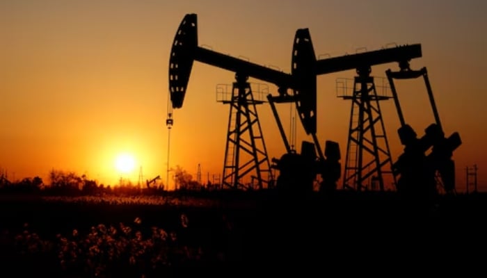 Pumpjacks are seen against the setting sun at the Daqing oil field in Heilongjiang province, China December 7, 2018. — Reuters