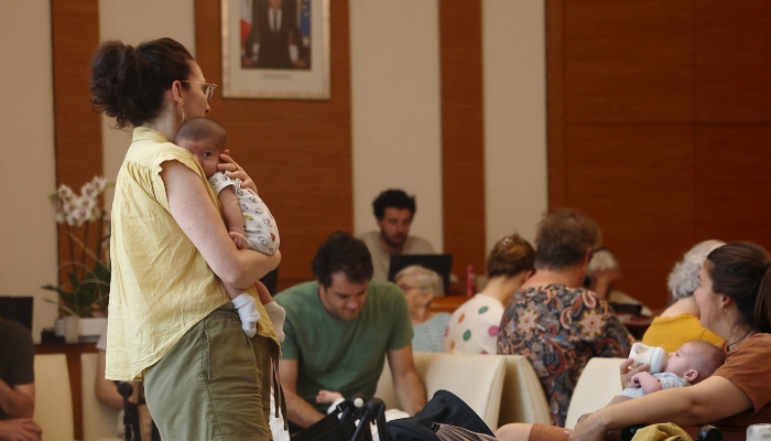 Families with young children gather inside an air-conditioned room open to the public inside the 17th district city hall as temperatures rise in Paris, France, June 25, 2026. — Reuters