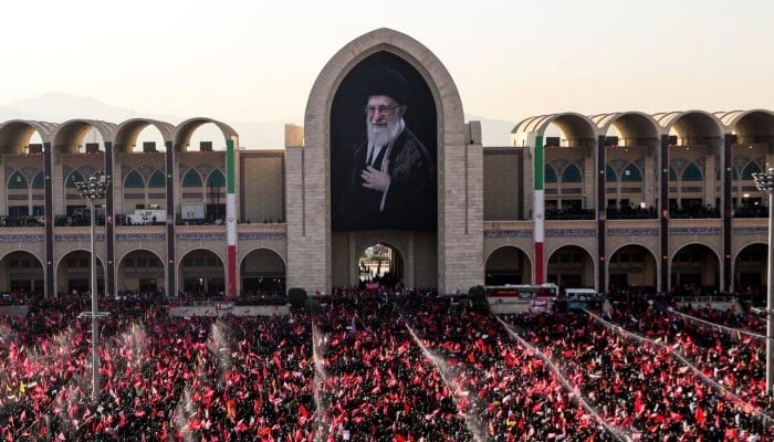 A portrait of late Supreme Leader Ayatollah Ali Khamenei hangs at the Imam Khomeini Grand Mosalla, as mourners attend a public farewell ceremony in Tehran, Iran, July 5, 2026. — X/@ISNAMEDIA