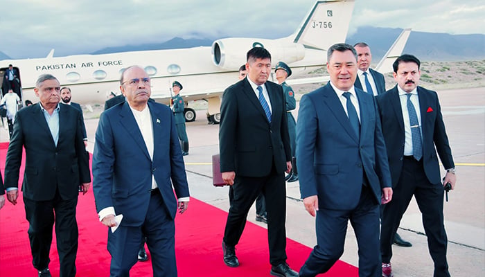 President Asif Ali Zardari (front-left) walks with Kyrgyz President Sadyr Japarov (front-right) at Issyk-Kul International Airport as he begins four-day official visit to Kyrgyzstan on July 6, 2026. — X@MediaCellPPP