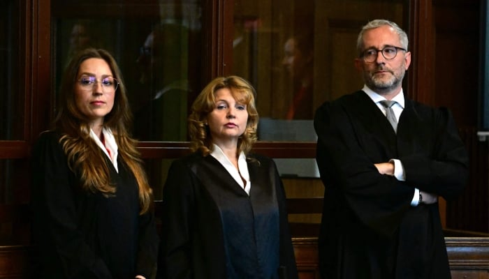 The court-appointed defendants lawyers, Klaudia Dawidowic (from left to right), Ria Halbritter and Christoph Stoll wait for the start of the trial of a palliative care doctor allegedly accused of killing 15 patients with lethal injections, in the Regional Courtroom in Berlin, on July 14, 2025. — AFP