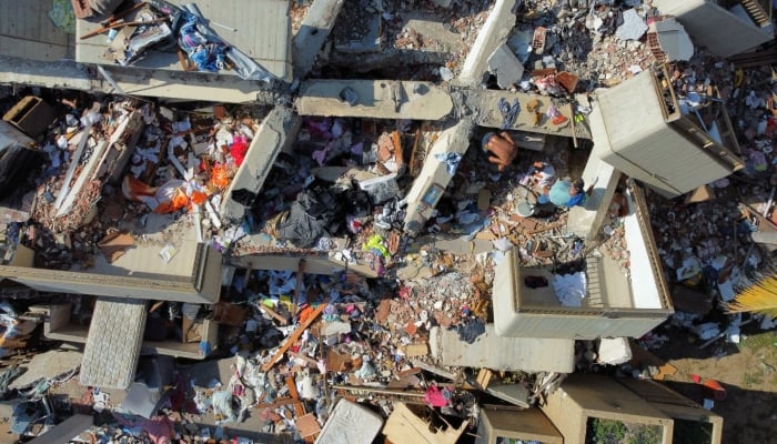 A drone view of people inspect a damaged apartment in the aftermath of the June 24 earthquakes, in Macuto, La Guaira state, Venezuela July 8, 2026. — Reuters