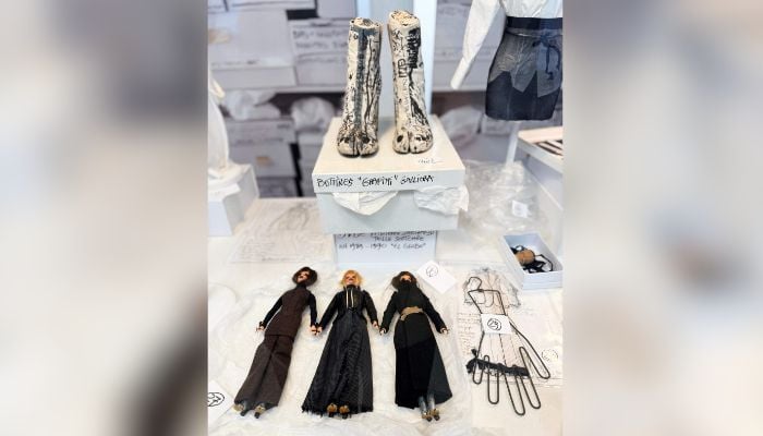 This photograph shows three barbies dressed by Martin Margiela in looks from his collection from the nineties during an exhibition at the Quartier General in Paris on July 7, 2026. — AFP