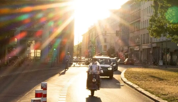 A man rides a scooter along a sunny street in the Kreuzberg district during the ongoing heatwave in Berlin, Germany, June 26, 2026. —Reuters