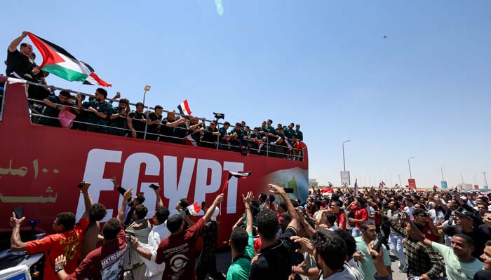 Egypts national soccer team ride on a bus as they are welcomed by fans at El Alamein International Airport upon their return from the 2026 FIFA World Cup, ahead of an official reception by President Abdel Fattah al-Sisi, in El Dabaa, Egypt, July 10, 2026. — Reuters