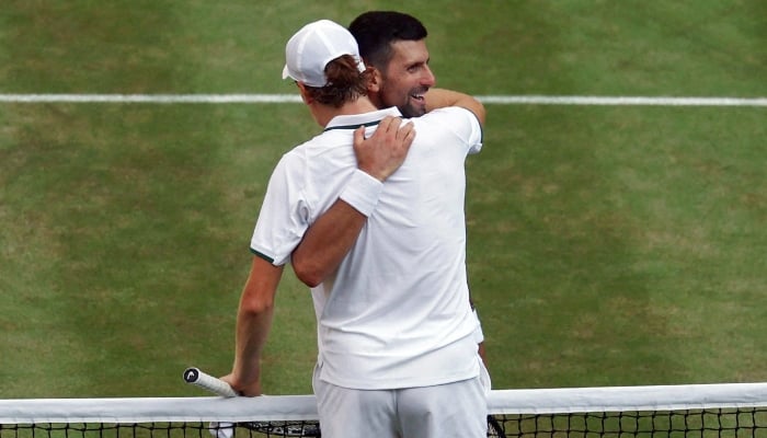 Italys Jannik Sinner embraces Serbias Novak Djokovic after winning their semi final match on July 10, 2026. — Reuters