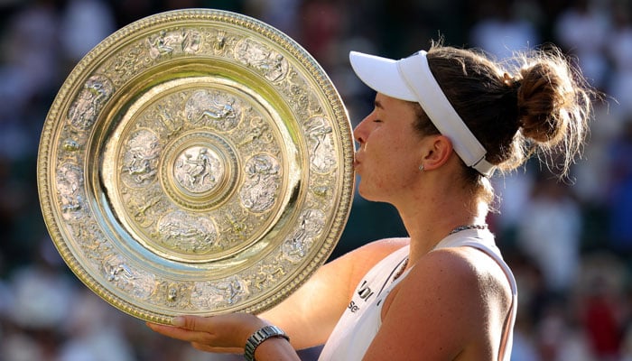 Czech Republics Linda Noskova celebrates with the trophy after winning her final match against Czech Republics Karolina Muchova at The All England Lawn Tennis and Croquet Club in Wimbledon, southwest London, on July 11, 2026. — Reuters