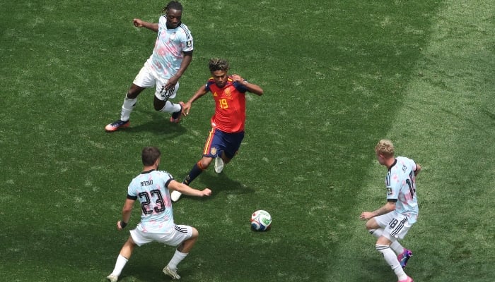 Spains forward #19 Lamine Yamal fights for the ball with Belgiums midfielder #23 Nicolas Raskin, defender #18 Joaquin Seys and forward #11 Jeremy Doku during the 2026 World Cup football tournament quarter-final match between Spain and Belgium at the Los Angeles Stadium in Inglewood on July 10, 2026. — AFP
