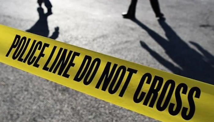 People stand behind a crime scene tape. — AFP/File