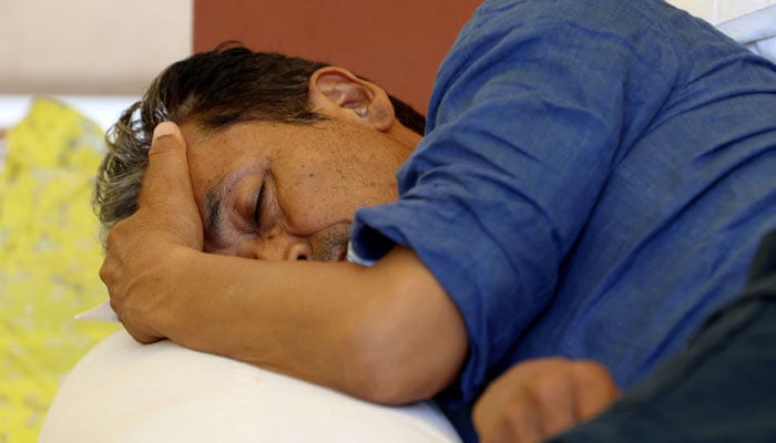 Sonam Wangchuk, an Indian education reformer, who has been on hunger strike, rests on stage during a sit-in protest called by CJP demanding the resignation of Indian Education Minister Dharmendra Pradhan, at Jantar Mantar in New Delhi, India, July 14, 2026. — Reuters