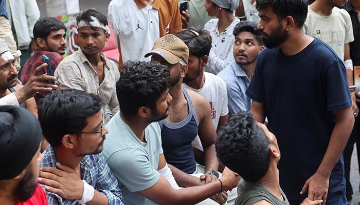 Abhijeet Dipke, head of the Cockroach Janta Party (CJP) meets injured supporters, at Jantar Mantar, New Delhi, India, July 21, 2026. — Reuters