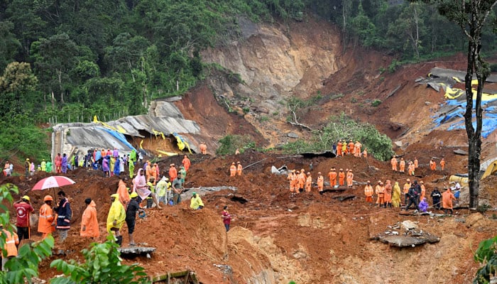 Image shows rescuers works on the debris following a landslide near a tunnel. — Reuters