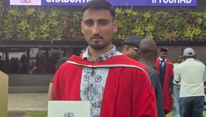 Kamran Hayat, the son of slain journalist Hayatullah Khan, poses after securing his degree at a UK university. — Reporter