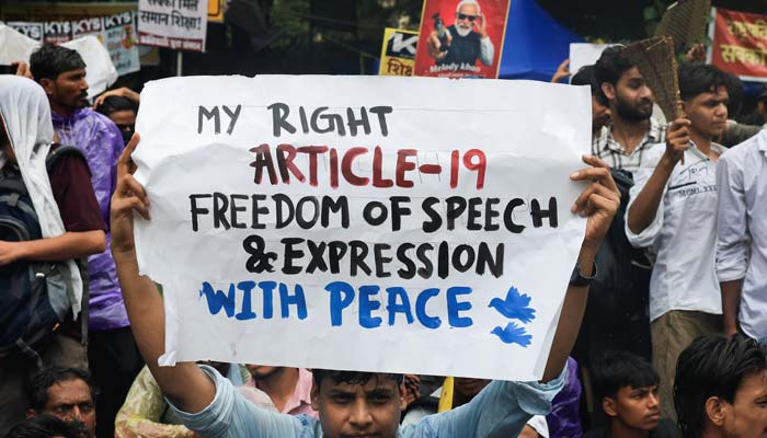 A protester holds a placard during an ongoing protest, days after thousands of protesters marched towards parliament demanding the resignation of Education Minister Dharmendra Pradhan over examination paper leaks, at Jantar Mantar in New Delhi, India, July 24, 2026. — Reuters