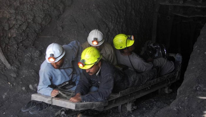This representational image shows miners working inside a coal mine. — AFP