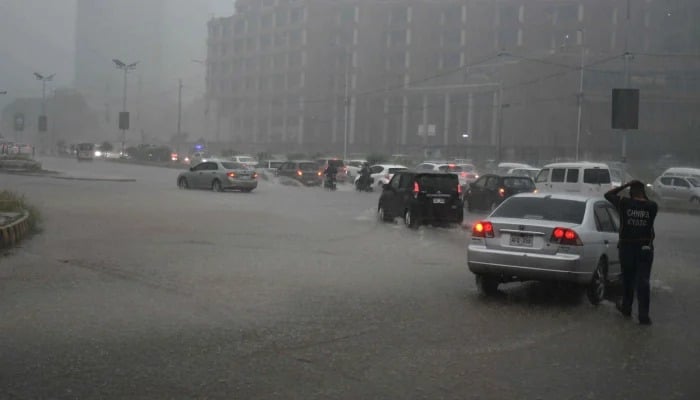 Motorists drive during heavy rainfall in Karachi on April 2, 2026. —  Online