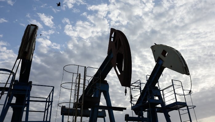 Birds fly over pump jacks at the Airankol oil field operated by Caspiy Neft in the Atyrau region, Kazakhstan, April 20, 2026. — AFP