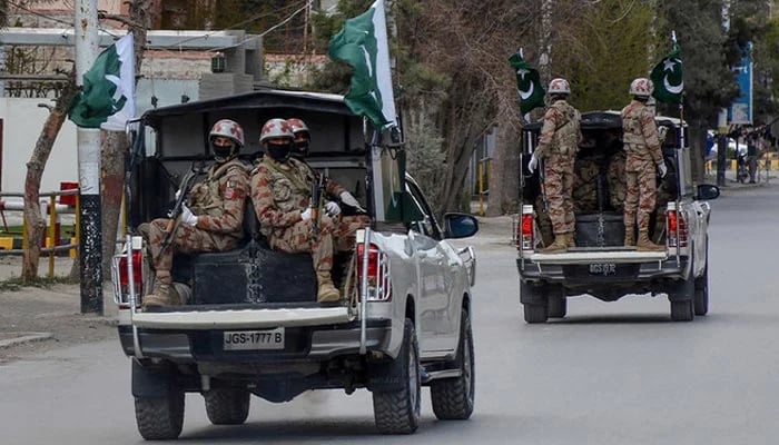Security personnel patrol with vehicles on a street in Quetta. — AFP/File